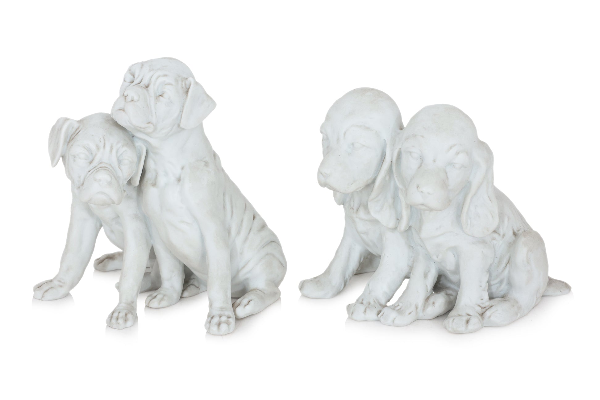 A PAIR OF KAISER GERMAN BISQUE PORCELAIN DOGS