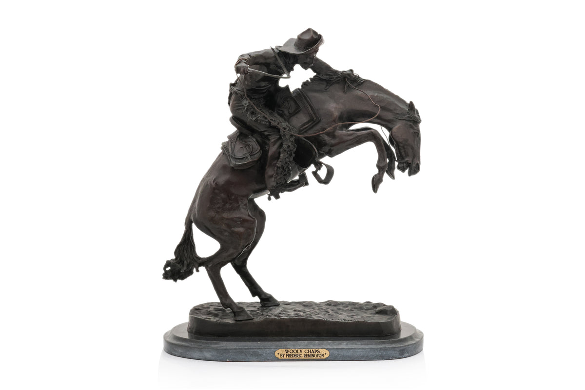 A SPELTER SCULPTURE OF 'WOOLY CHAPS' AFTER THE MODEL BY FREDERIC REMINGTON
