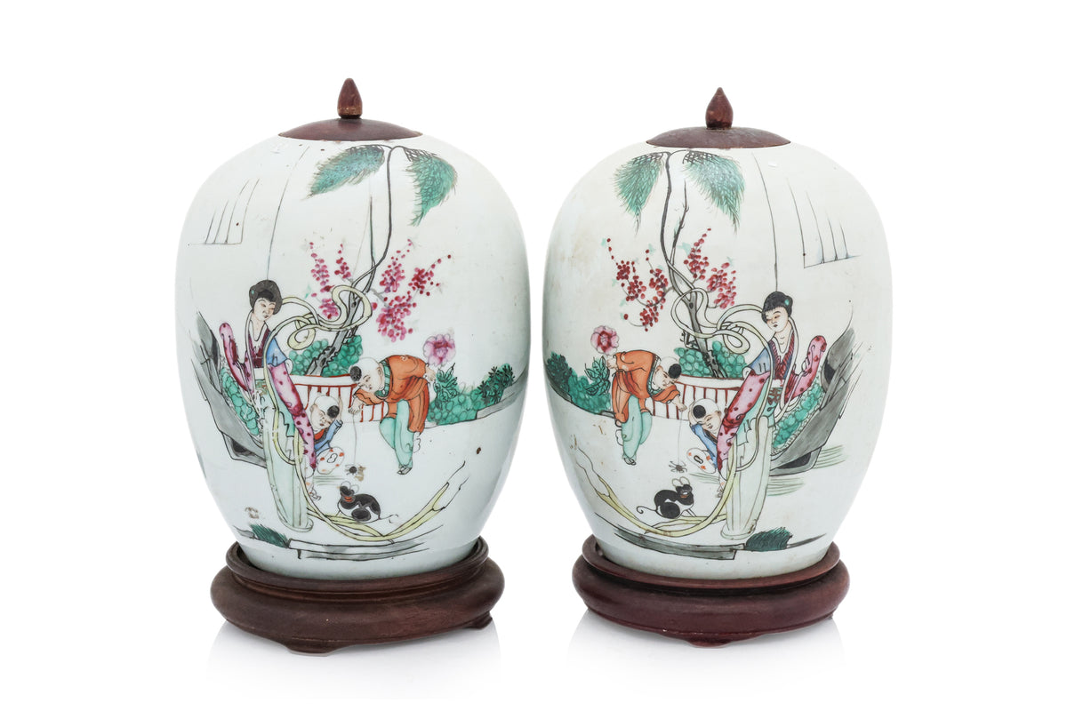 A PAIR OF FAMILLE ROSE JAR AND COVERS