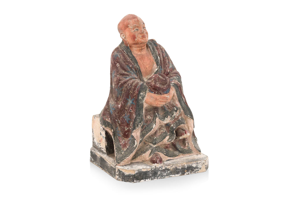 A POLYCHROME POTTERY FIGURE OF A LUOHAN