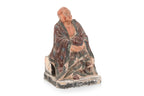 A POLYCHROME POTTERY FIGURE OF A LUOHAN