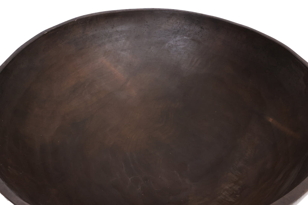 A GRADUATED PAIR OF LARGE WOODEN BOWLS BY CALVIN KLEIN
