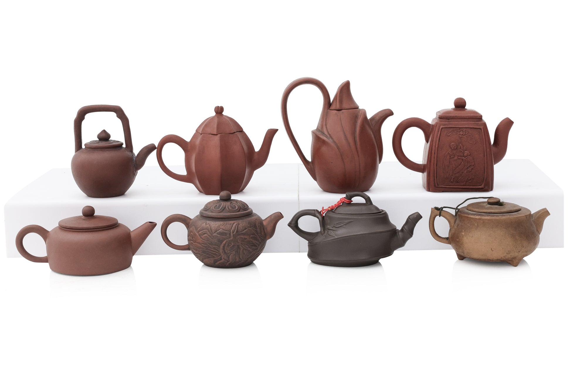 A GROUP OF EIGHT YIXING ZISHA POTTERY TEAPOTS