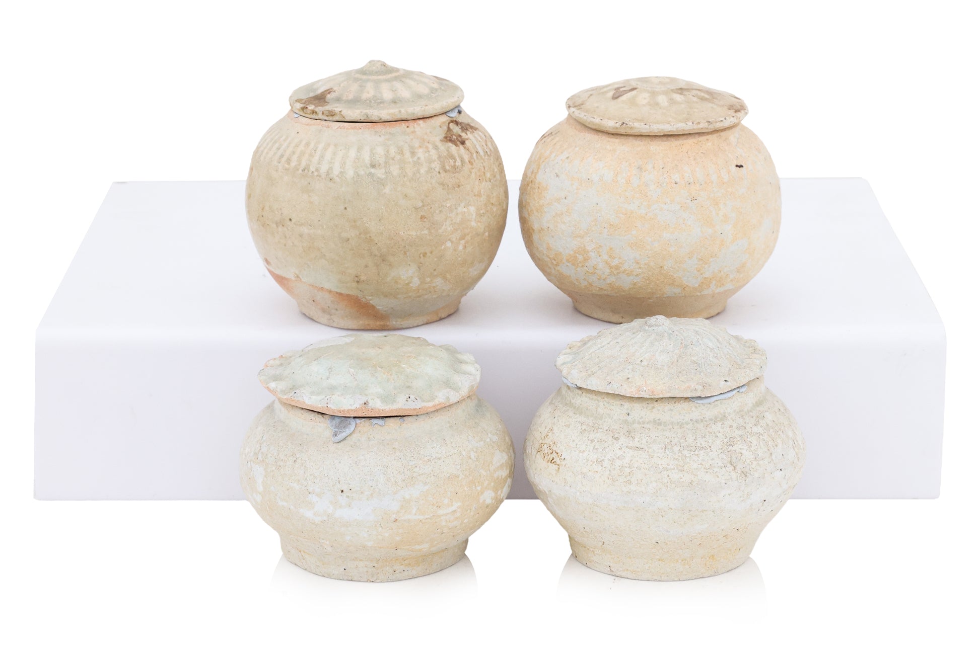 A GROUP OF QINGBAI-GLAZED JARS AND COVERS