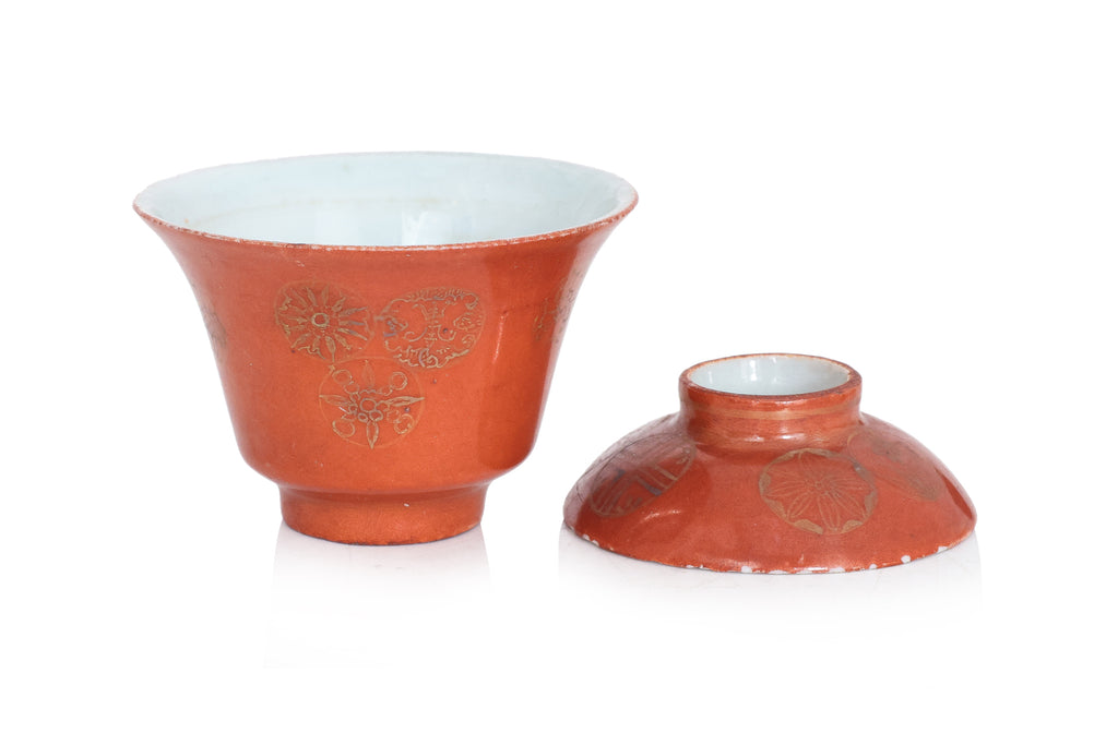 TWO SMALL CORAL GROUND TEA BOWLS WITH COVERS AND SAUCERS