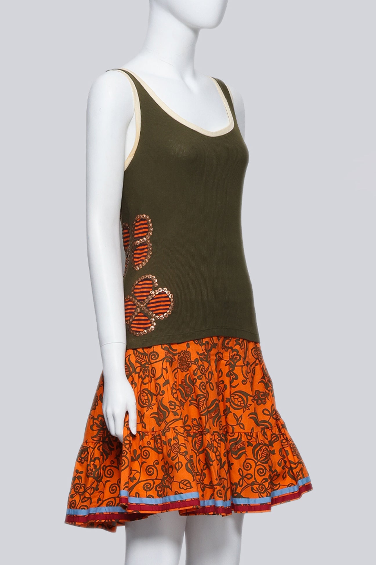 ISABELA CAPETO - AN OLIVE TANK TOP AND ORANGE FLORAL SKIRT