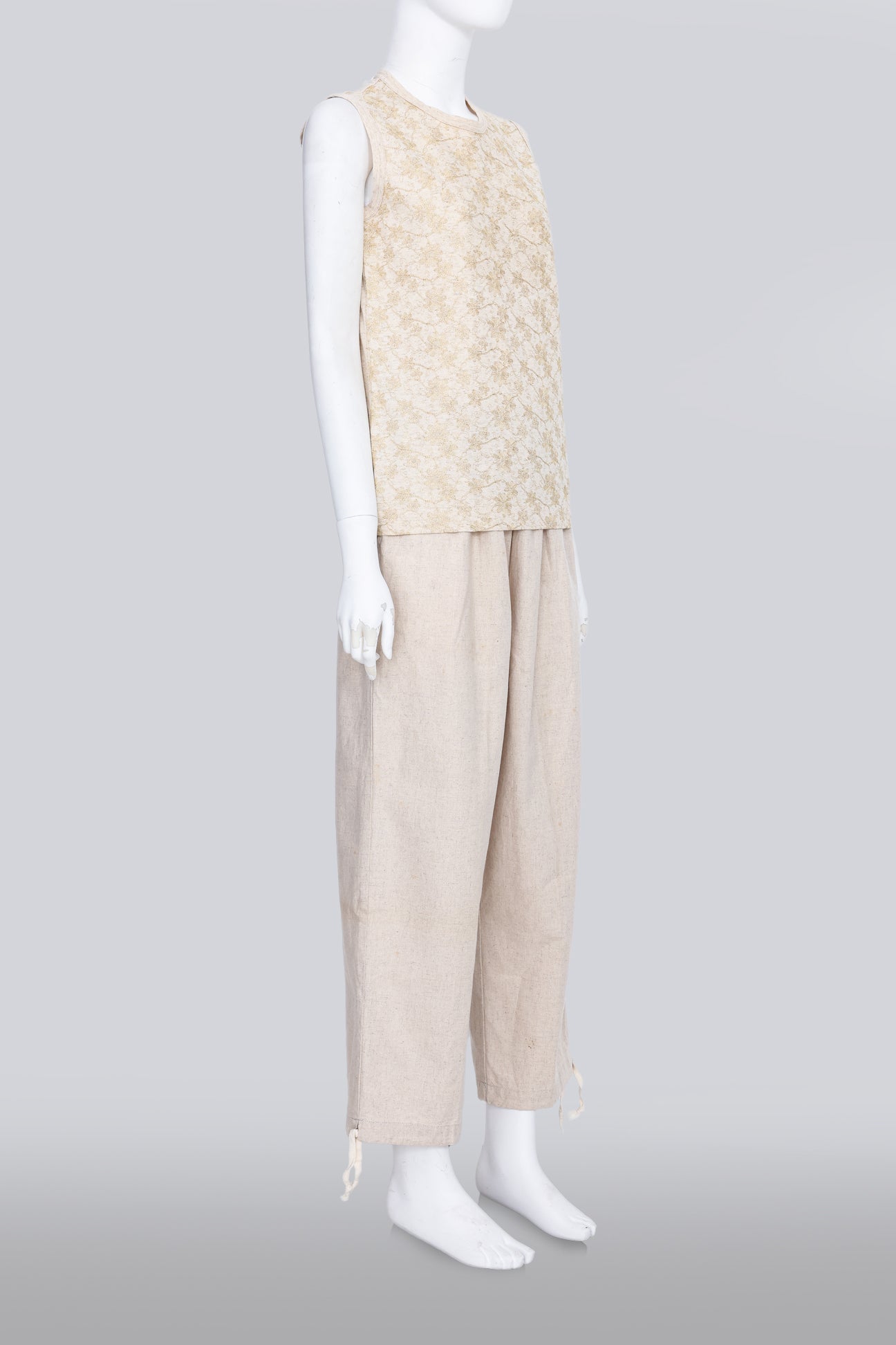 COMME DES GARCONS TRICOT - A 2007 SLEEVELESS TAN GOLD EMBROIDERED SHIRT AND TAN TROUSERS ENSEMBLE