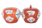 A PAIR OF CORAL GROUND FAMILLE ROSE PORCELAIN JARS