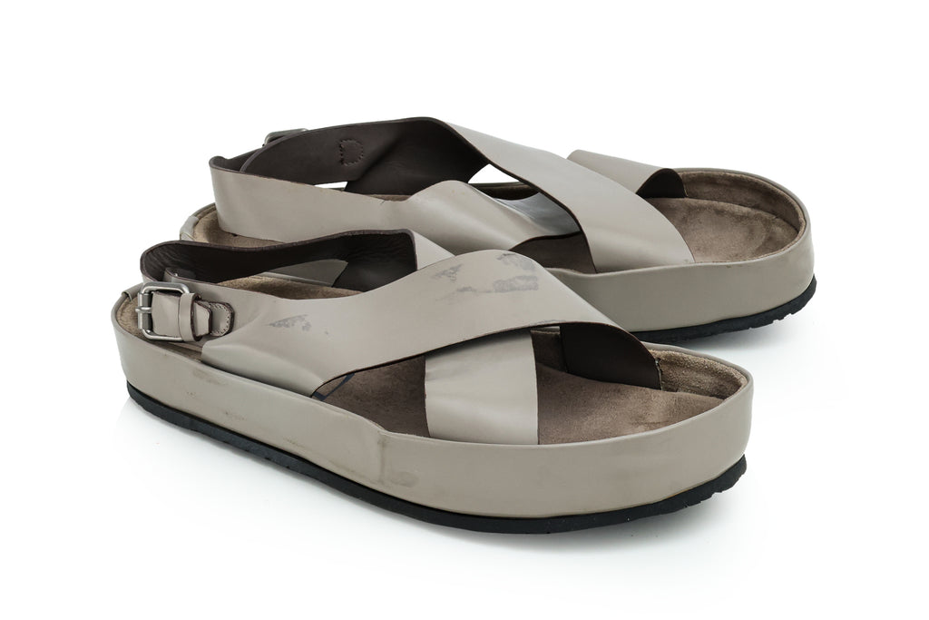 YVES SAINT LAURENT - A PAIR OF GREY LEATHER CROSS-STRAP SANDALS
