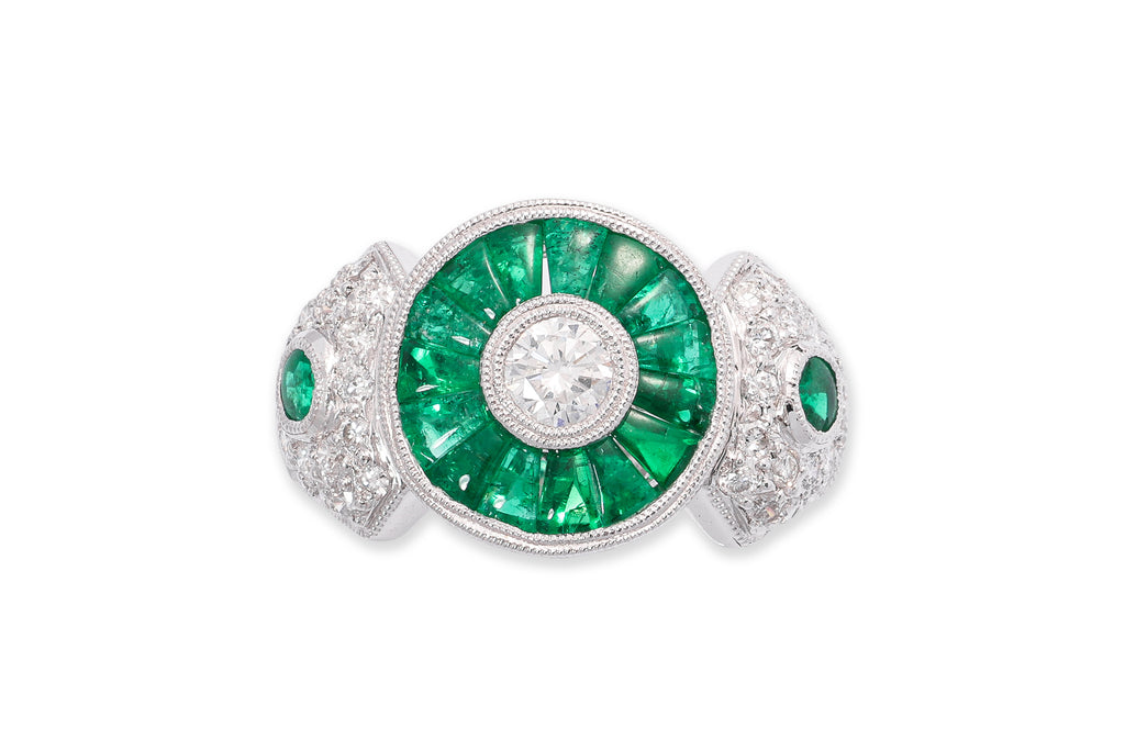 A DIAMOND AND EMERALD RING
