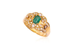 AN EMERALD AND DIAMOND CLUSTER RING