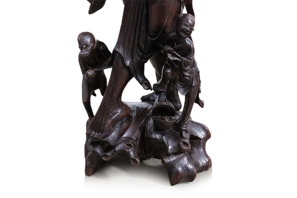 A VERY LARGE CHINESE CARVED HARDWOOD FIGURAL FLOOR LAMP