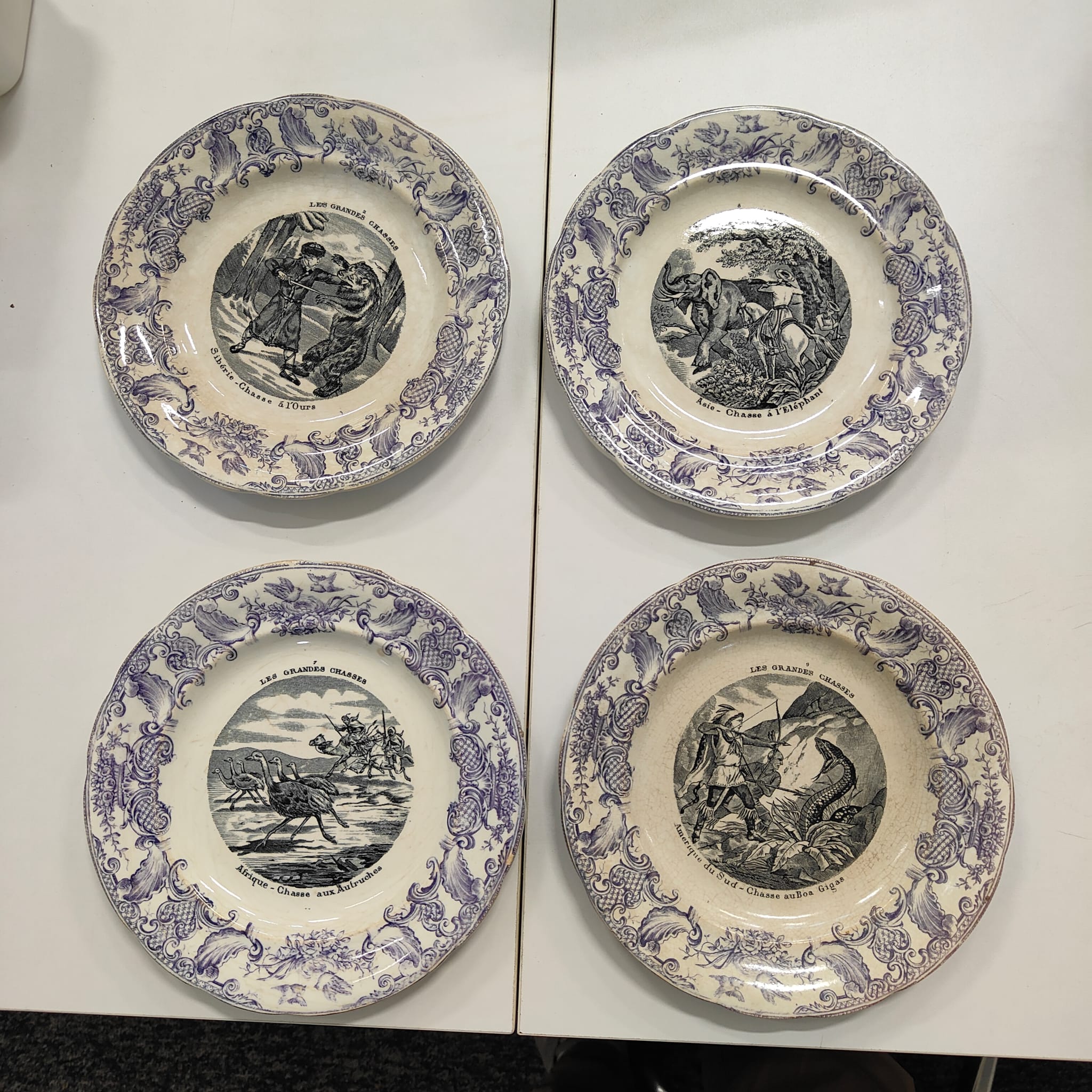A PART SET OF FOUR FRENCH OPAQUE DE GIEN 'LES GRANDE CHASSES' PORCELAIN PLATES