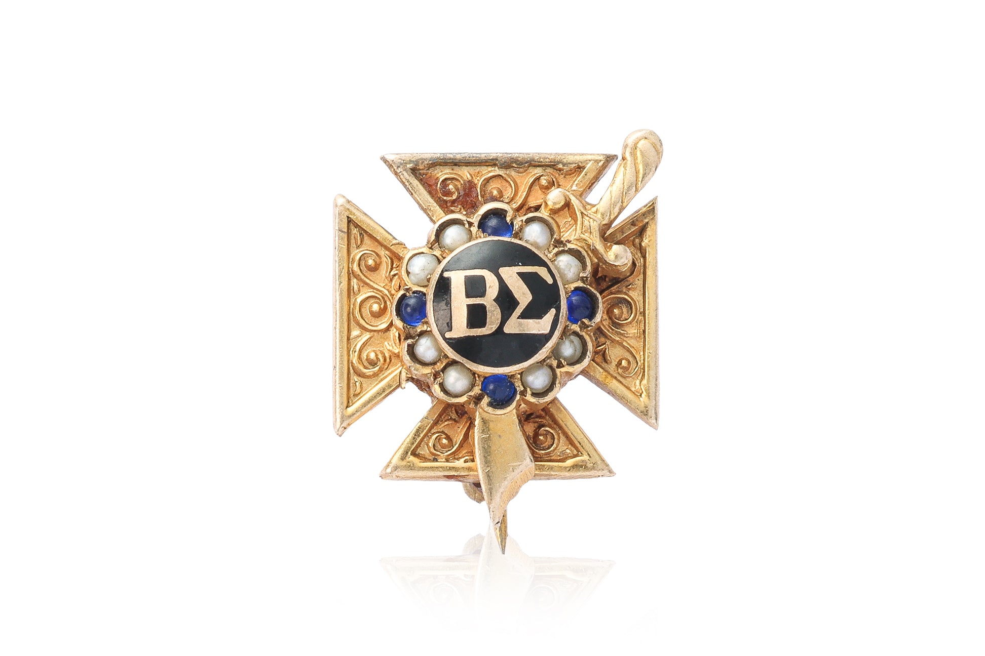 A GOLD SORORITY BADGE