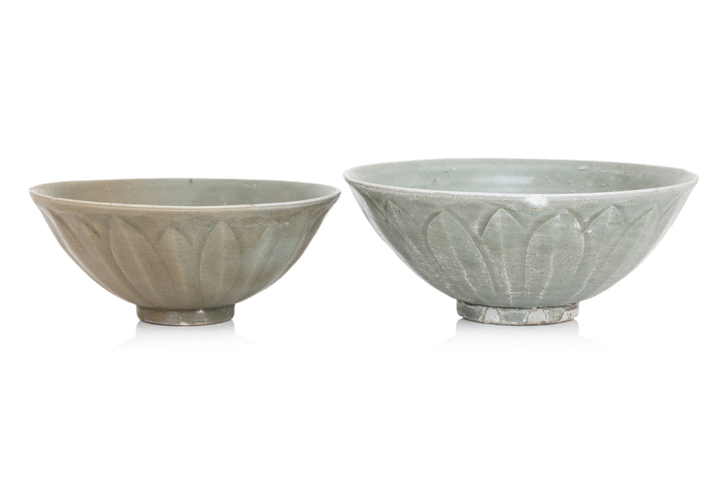 TWO YAOZHOU CELADON GLAZED 'LOTUS' BOWLS