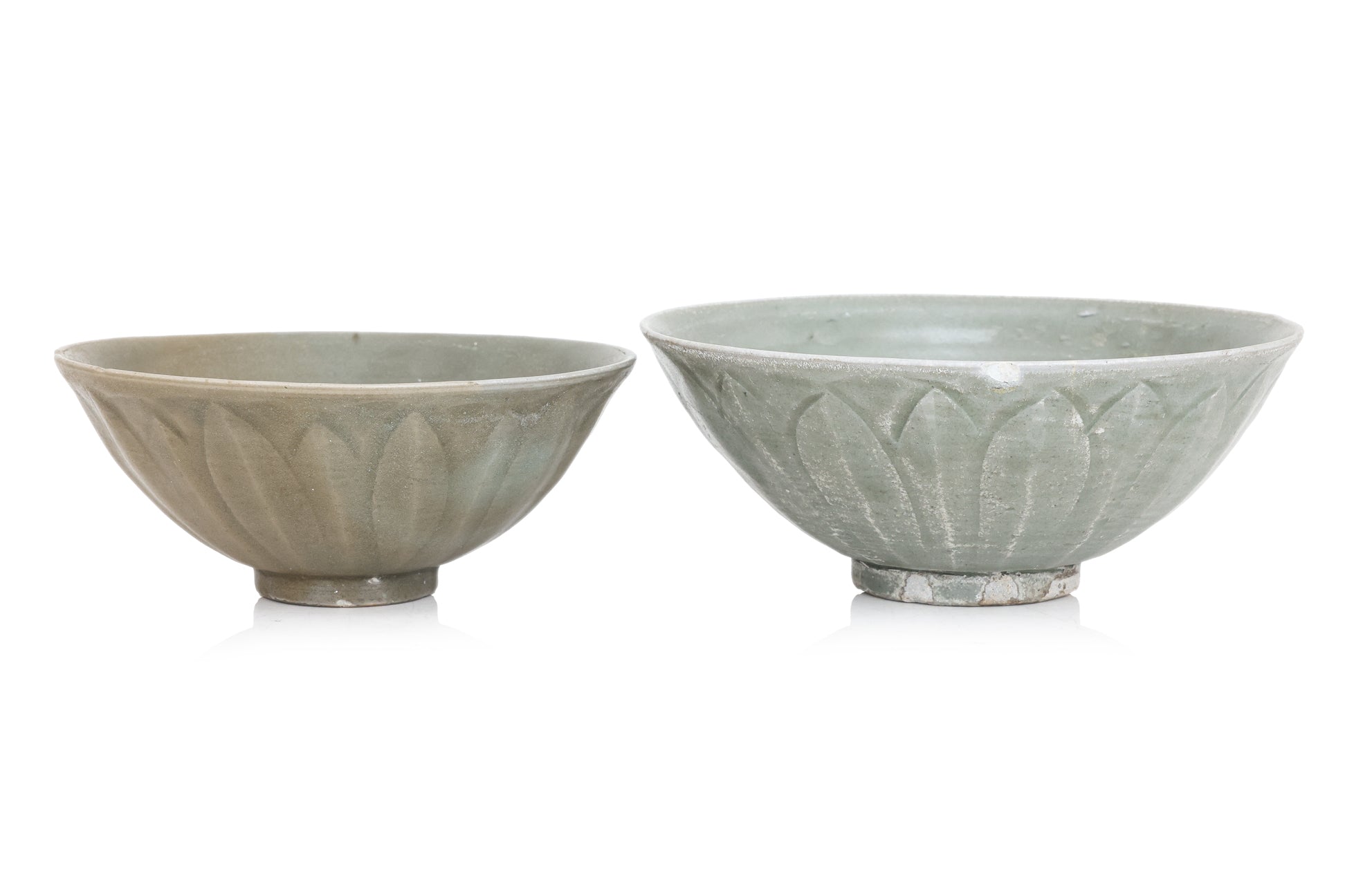 TWO YAOZHOU CELADON GLAZED 'LOTUS' BOWLS