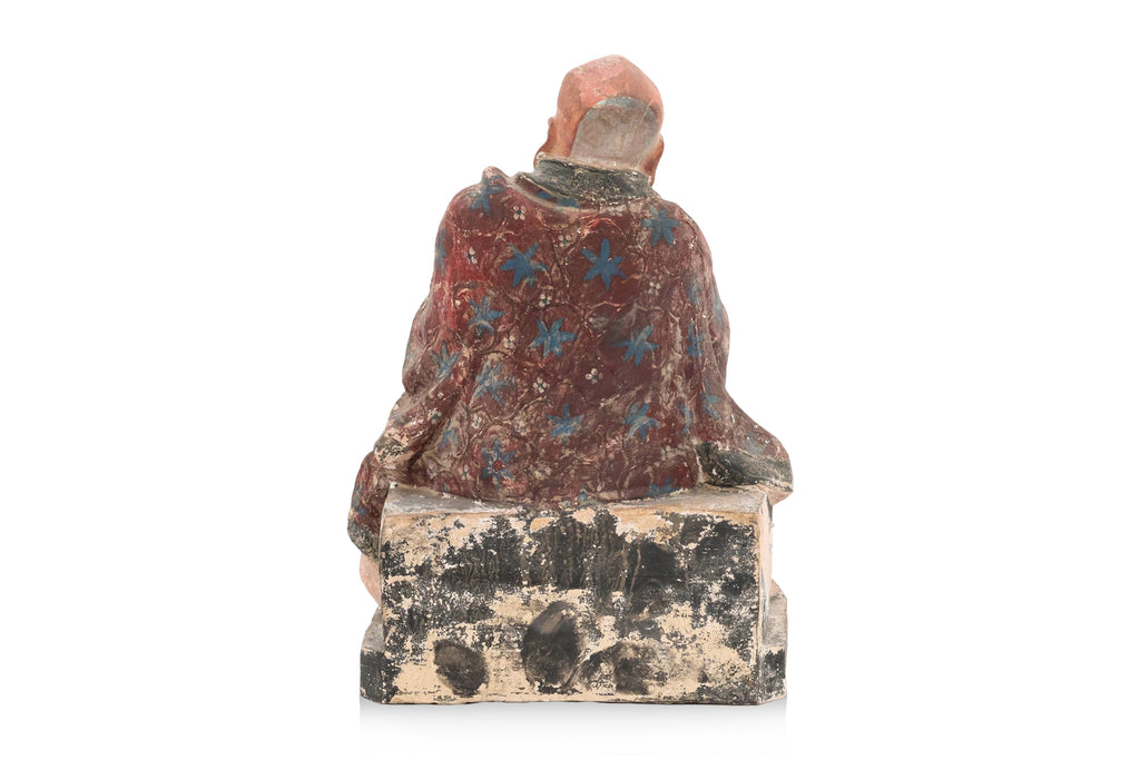 A POLYCHROME POTTERY FIGURE OF A LUOHAN