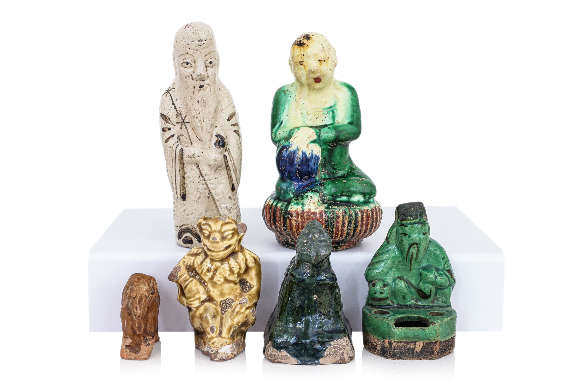 A GROUP OF SIX POTTERY FIGURES