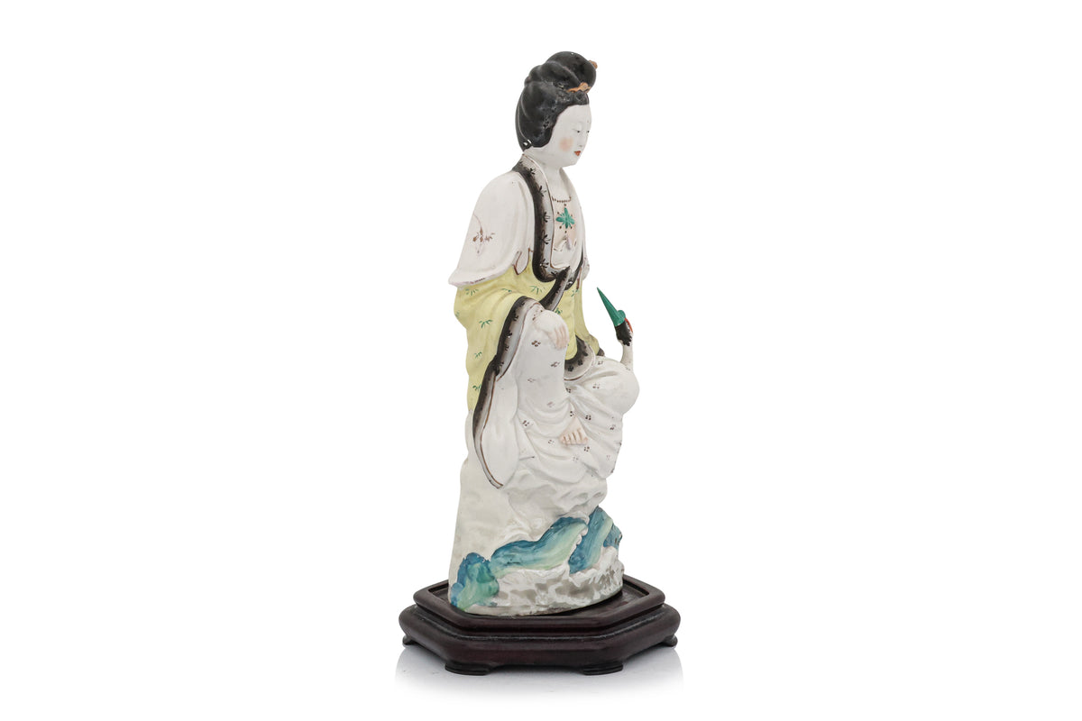 A POLYCHROME-ENAMELLED PORCELAIN FIGURE OF A WOMAN AND BIRD