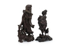 A SOAPSTONE AND A HARDWOOD CARVED FIGURE OF A MONK