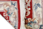 A CHINESE RED FLORAL WOOL HALL RUNNER (69 X 244CM)