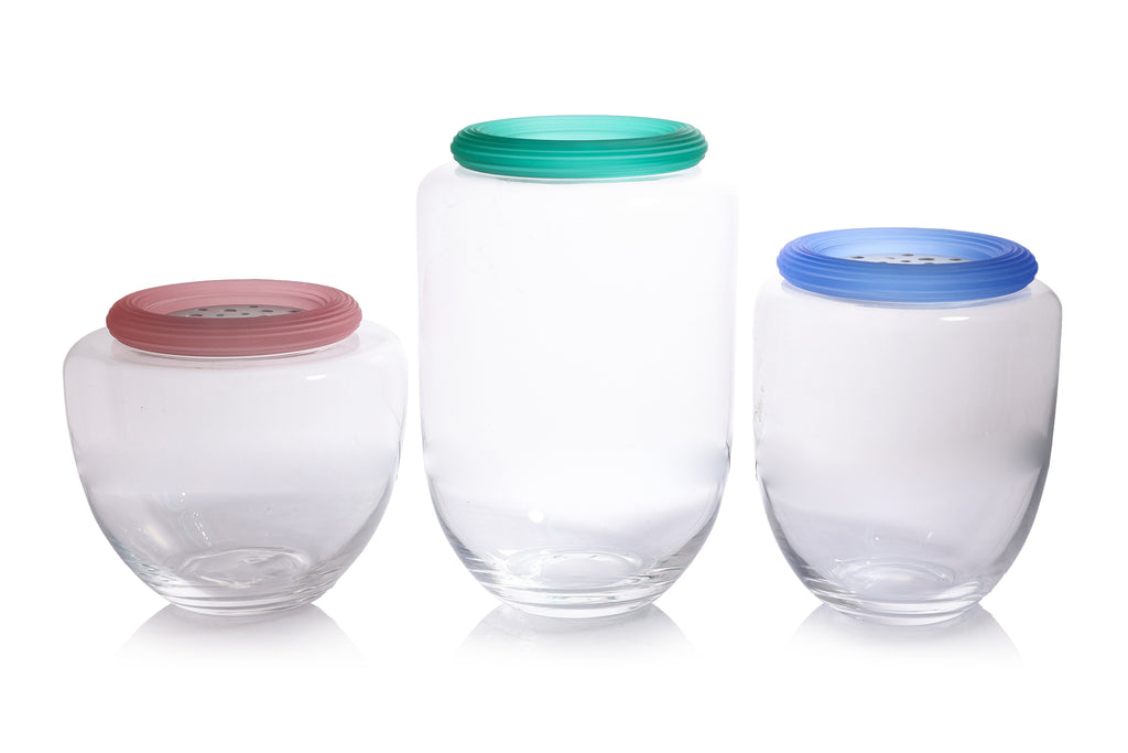 A GROUP OF THREE IVV GLASS JARS WITH COLOURED LIDS