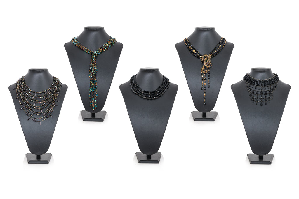 A GROUP OF FIVE COSTUME NECKLACES AND A SILVER TONED BANGLE