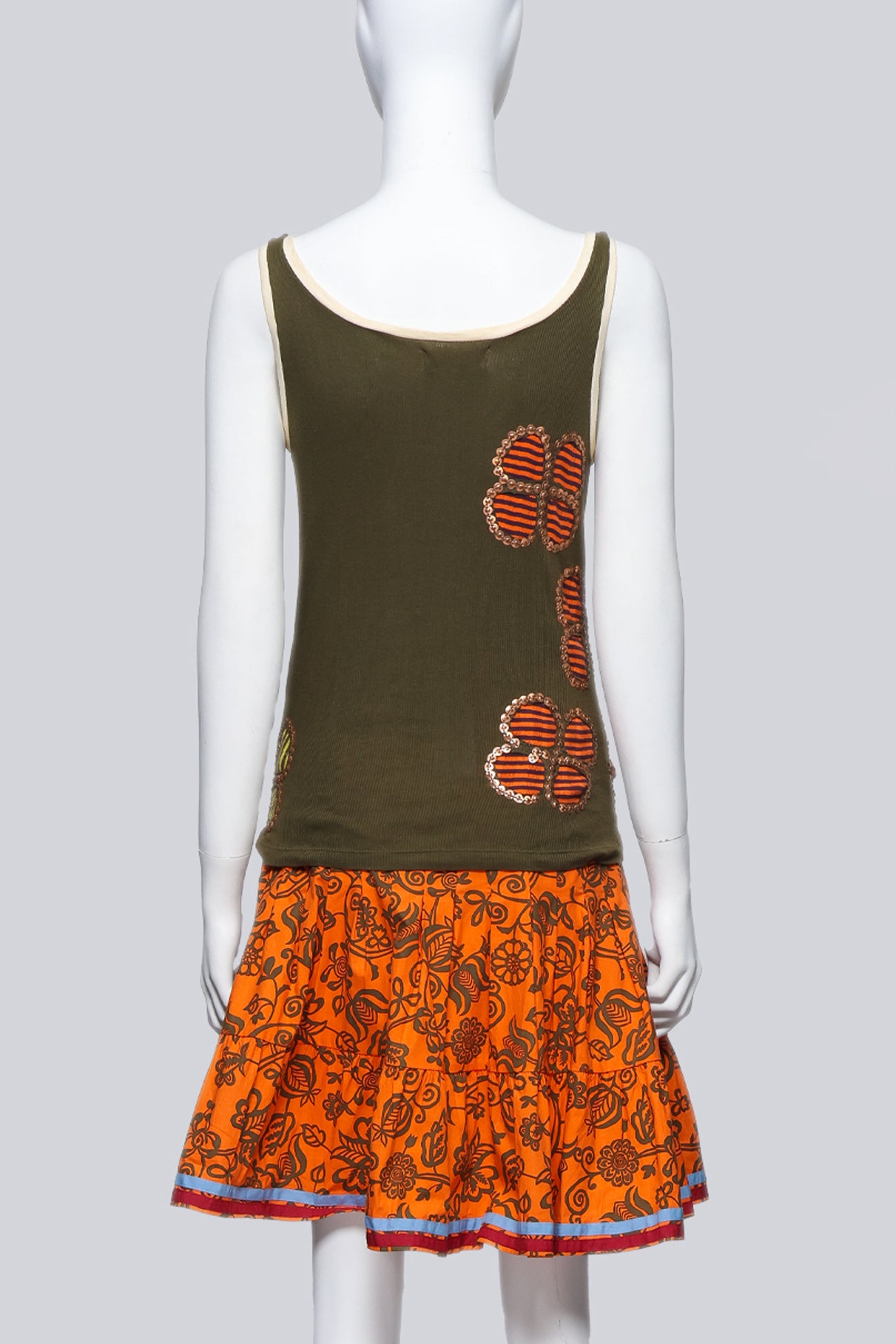 ISABELA CAPETO - AN OLIVE TANK TOP AND ORANGE FLORAL SKIRT