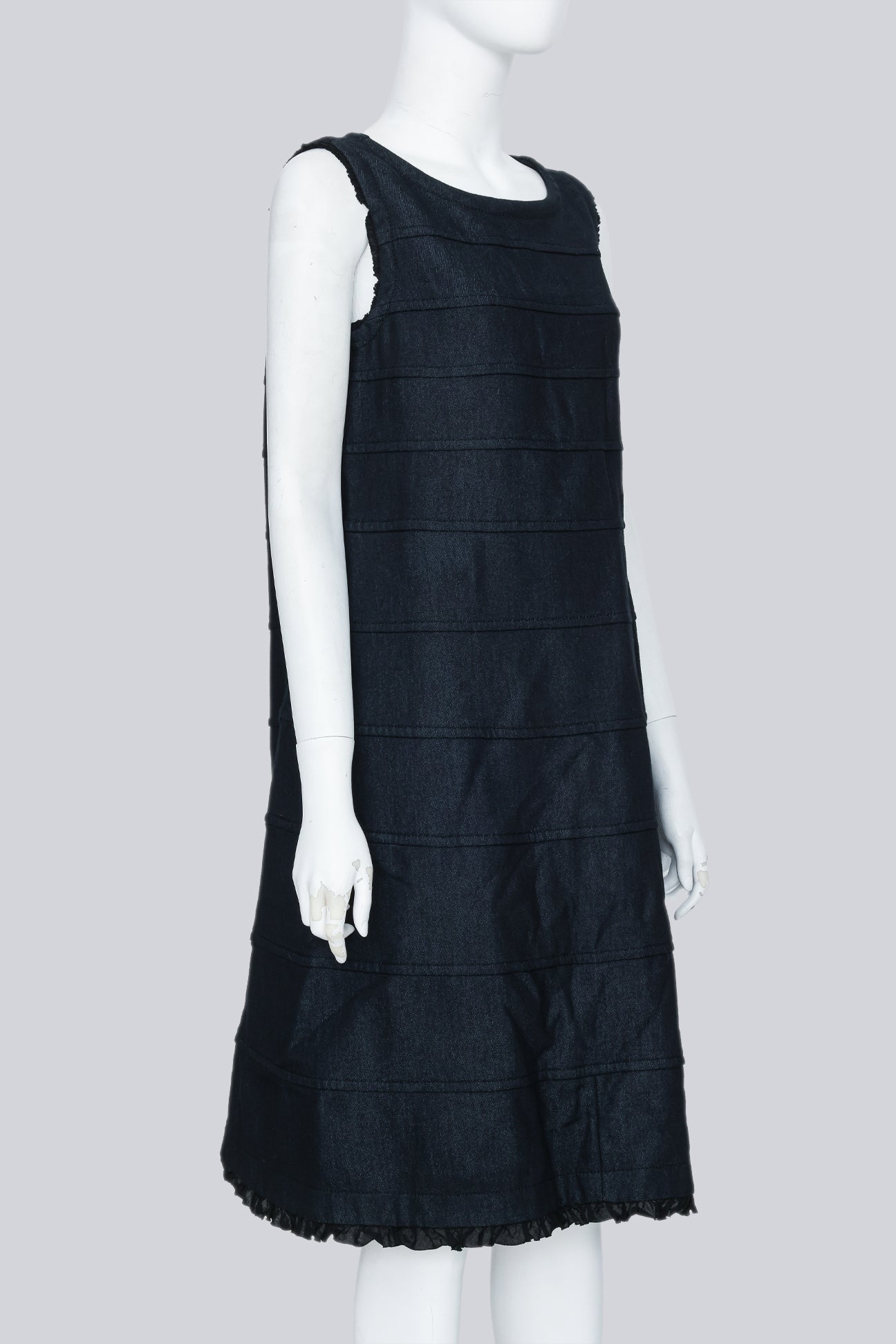 COMME DES GARÇONS TRICOT - A SLEEVELESS BLACK PANELLED DRESS WITH RUFFLED TRIM