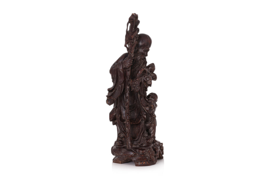 A CARVED HARDWOOD FIGURE OF SHOULAO