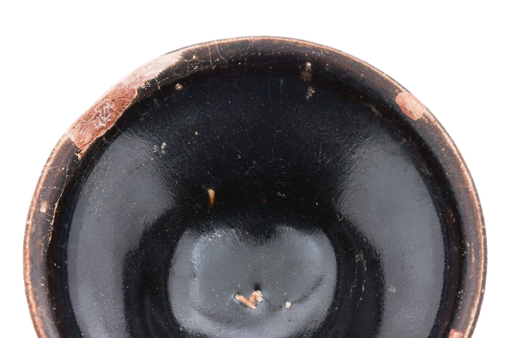 A BLACK-GLAZED STONEWARE BOWL