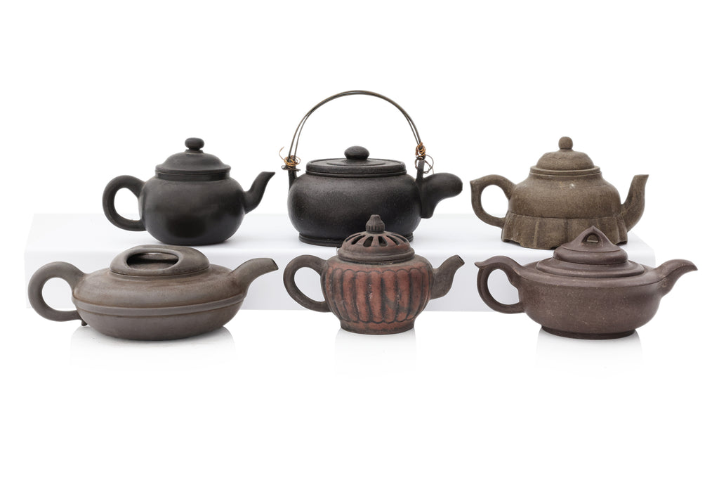 A GROUP OF SIX YIXING ZISHA POTTERY TEAPOTS