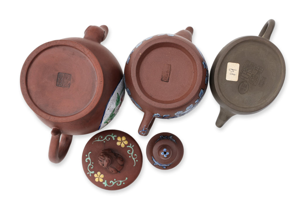 A GROUP OF THREE ENAMELLED YIXING ZISHA TEAPOTS