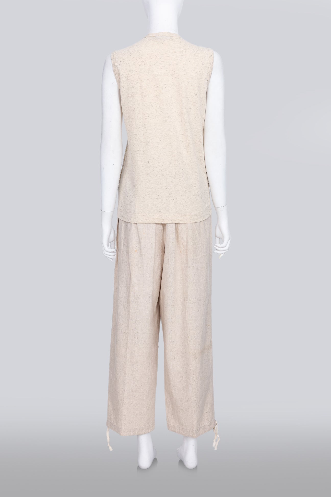 COMME DES GARCONS TRICOT - A 2007 SLEEVELESS TAN GOLD EMBROIDERED SHIRT AND TAN TROUSERS ENSEMBLE