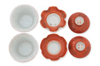 TWO SMALL CORAL GROUND TEA BOWLS WITH COVERS AND SAUCERS