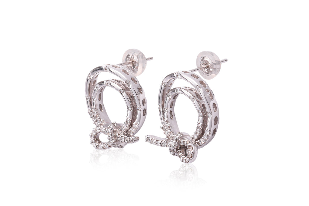 A PAIR OF DIAMOND SET CIRCULAR 'KNOT' EARRINGS