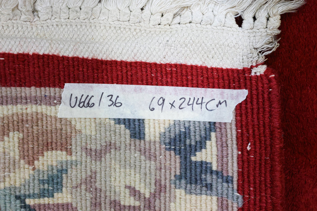 A CHINESE RED FLORAL WOOL HALL RUNNER (69 X 244CM)