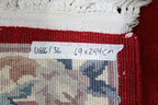 A CHINESE RED FLORAL WOOL HALL RUNNER (69 X 244CM)