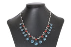 A BLUE TOPAZ, GARNET AND DIAMOND NECKLACE