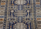 AN ANTIQUE CAUCASIAN WOOL RUG (165 X 125CM)