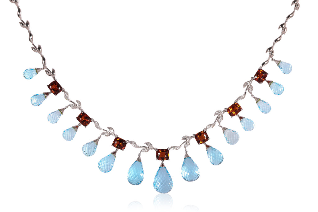 A BLUE TOPAZ, GARNET AND DIAMOND NECKLACE