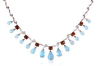 A BLUE TOPAZ, GARNET AND DIAMOND NECKLACE