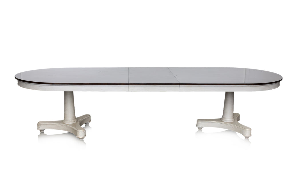 A LARGE EXTENDING OVAL DINING TABLE AND EIGHT CHAIRS