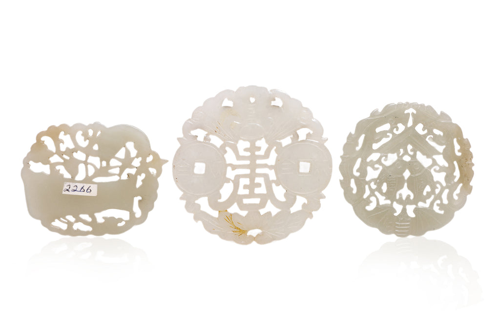 A GROUP OF THREE RETICULATED JADE PLAQUES