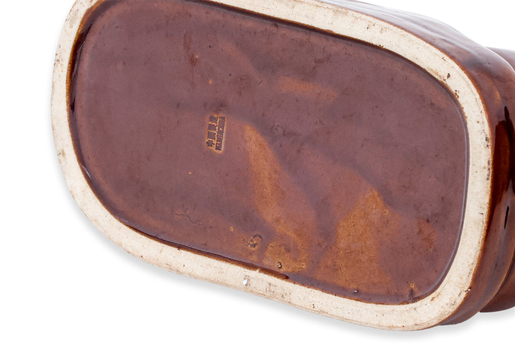 A GROUP OF THREE BROWN GLAZED CERAMIC PILLOW MONEY BOXES