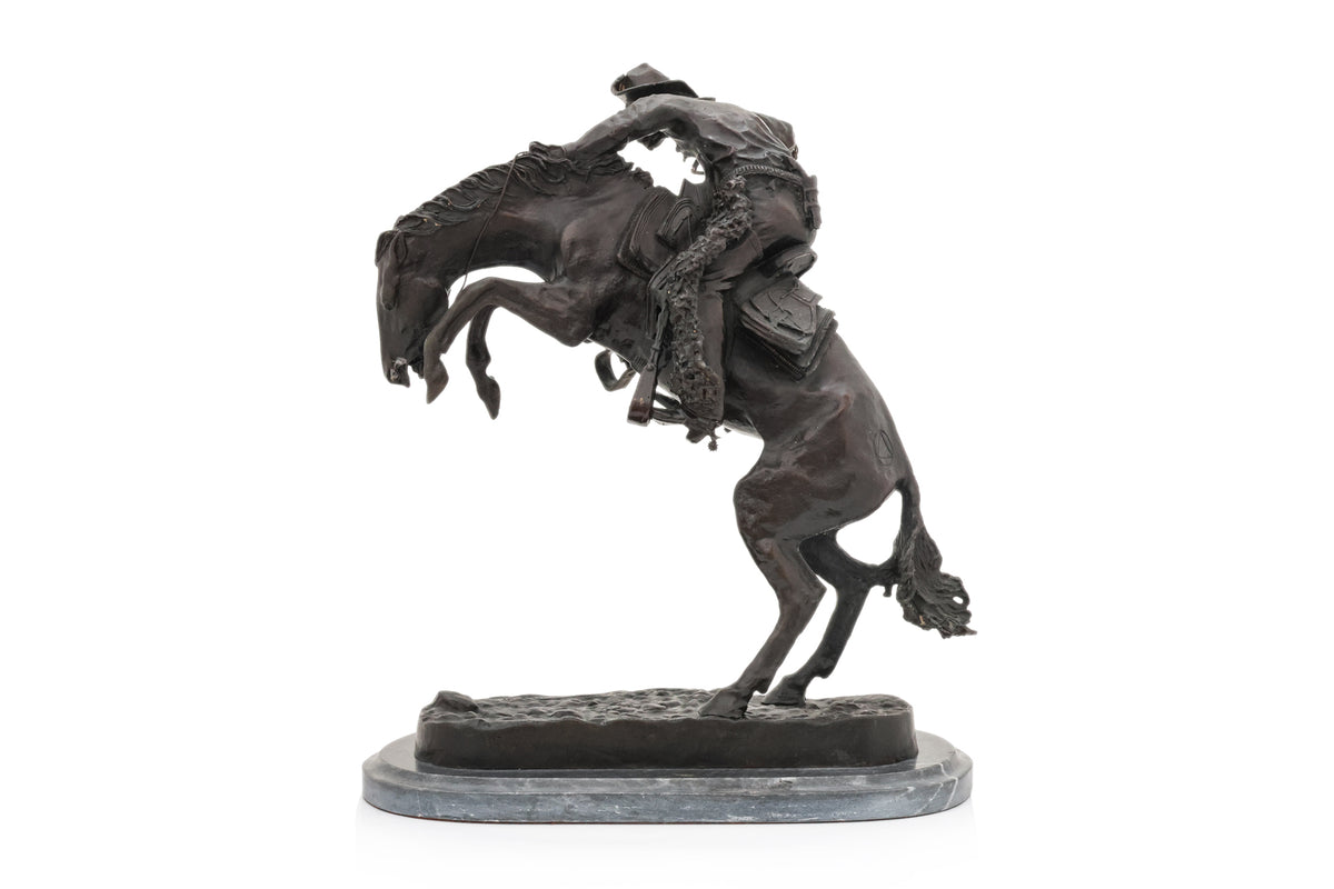 A SPELTER SCULPTURE OF 'WOOLY CHAPS' AFTER THE MODEL BY FREDERIC REMINGTON