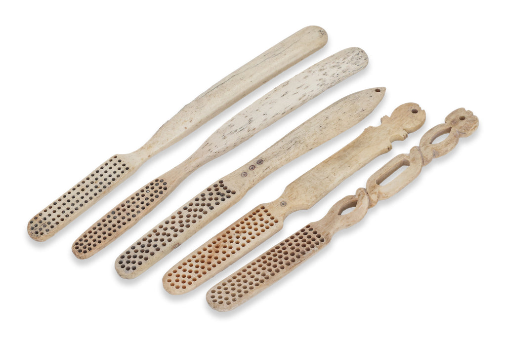A GROUP OF FIVE BONE TOOTHBRUSHES