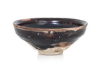 A BLACK-GLAZED STONEWARE BOWL