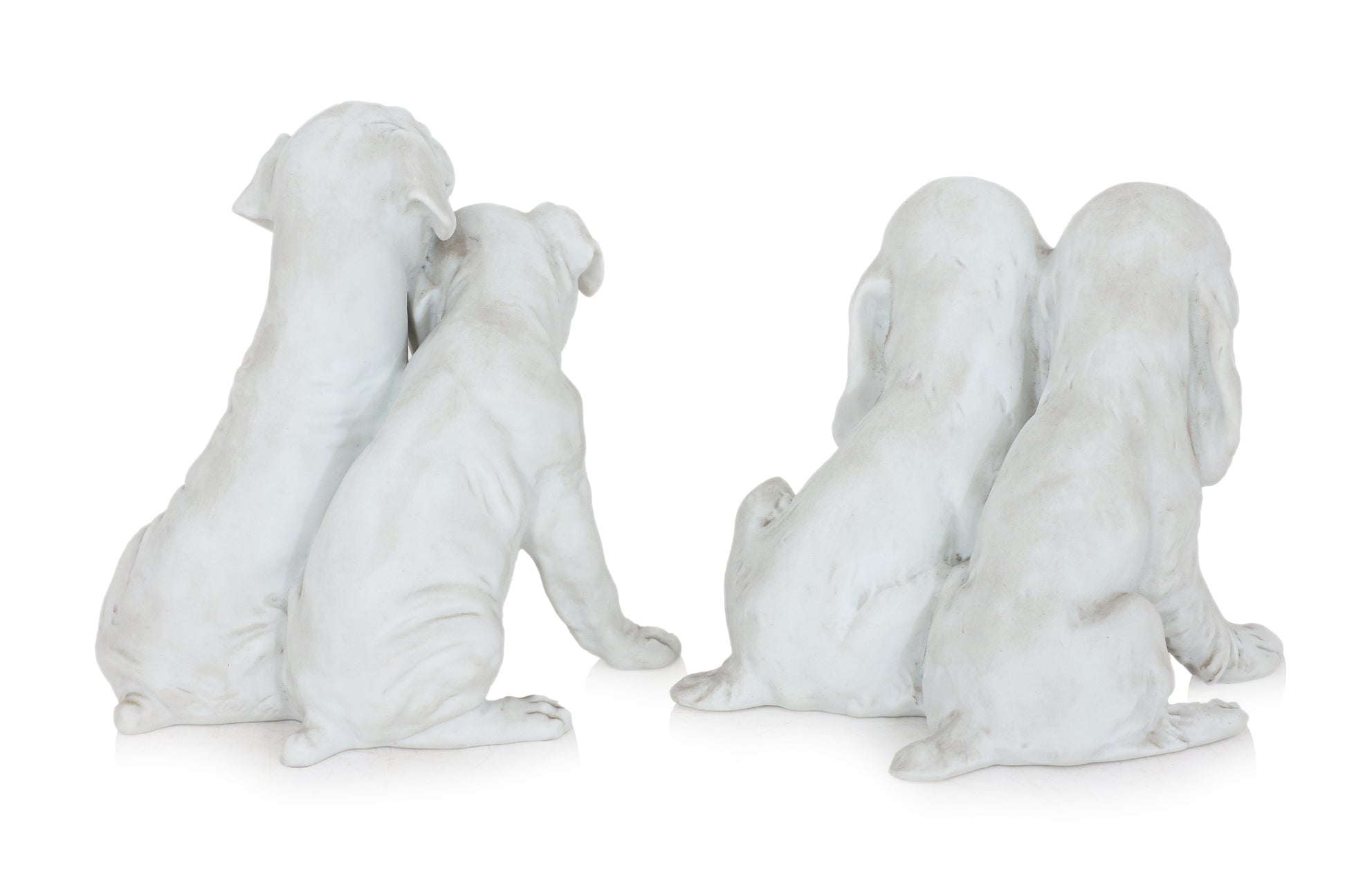 A PAIR OF KAISER GERMAN BISQUE PORCELAIN DOGS