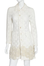 COMME DES GARÇONS - A LACE COAT WITH APPLIQUÉ KNITTED FLORAL MOTIF, 2011